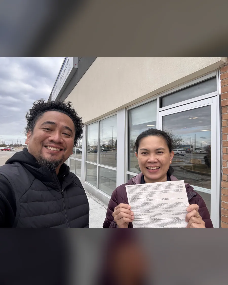 Student and instructor Allan outside the DriveTest centre, holding a road test result