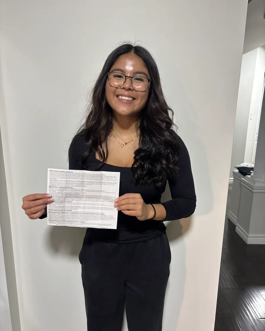 Student indoors holding the paperwork from their road test