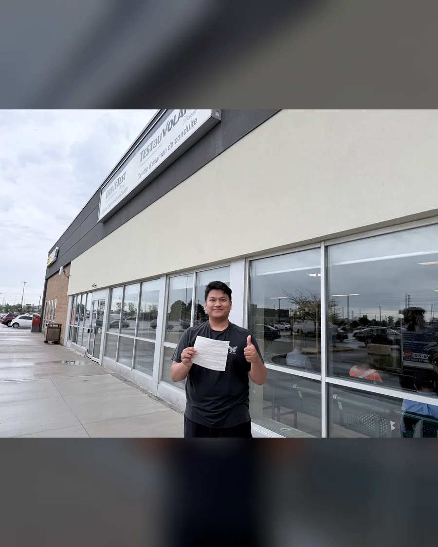 Student outside the DriveTest centre, holding their road test result